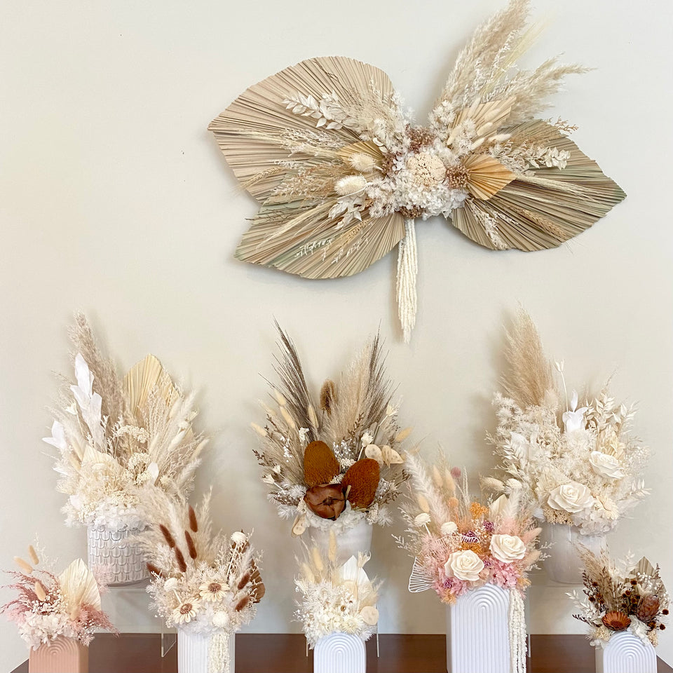 Dried and preserved flower arrangements on a side board